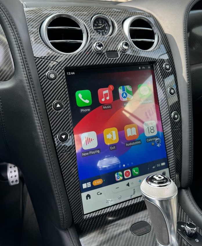 Bentley screen upgrade in carbon fiber trim, installed in a Continental GT with red leather interior