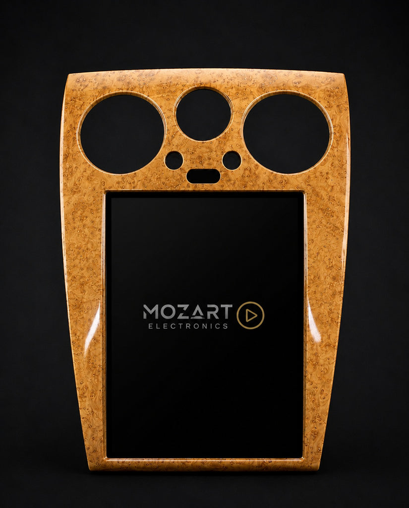 Light woodgrain trim frame for the Bentley Continental GT screen upgrade shown on a dark studio background
